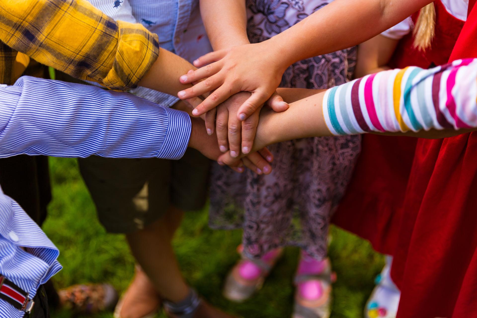 Kids joining hands together